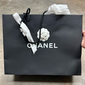 Authentic Chanel paper bag, with ribbon and camellia